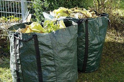 Large reusable rubbish bags full of green waste